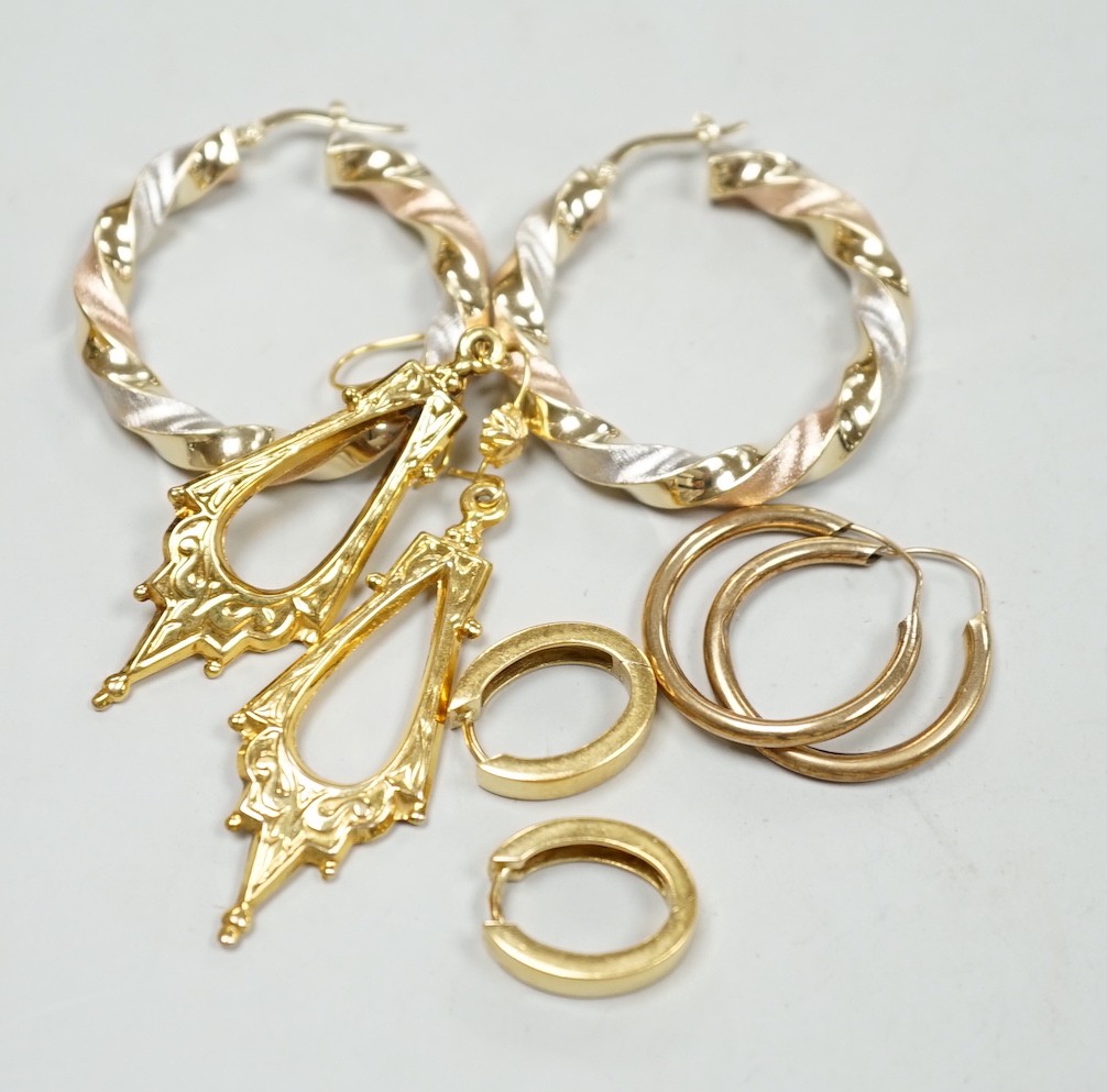 A modern pair of Italian three colour 14k hoop earrings, 35mm, 5.9 grams, a small pair of 750 oval earrings, 5.4 grams, a pair of 9ct gold Victorian style drop earrings, 2.7 grams and a pair of yellow metal hoop earrings